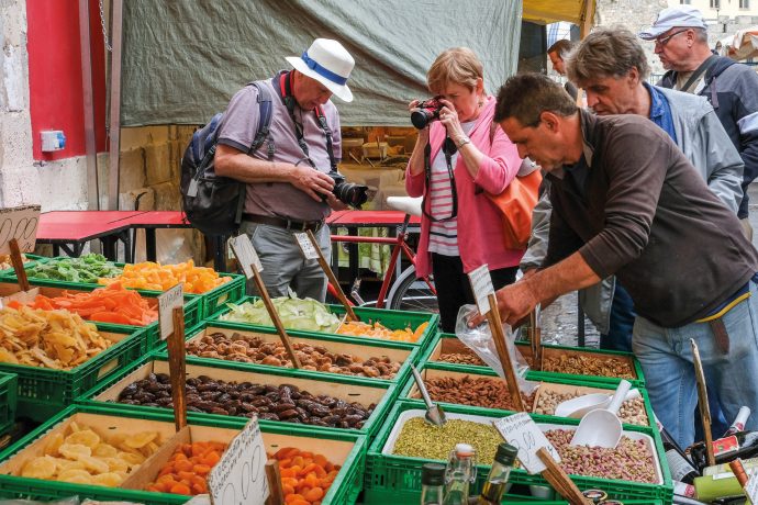 A group of guests taking a picture of the local markets