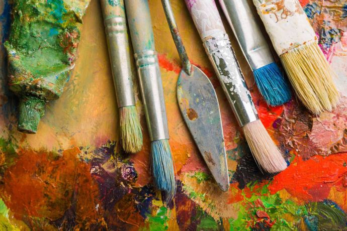 Paint brushes on a paint palette â€“ are you looking for art competitions?