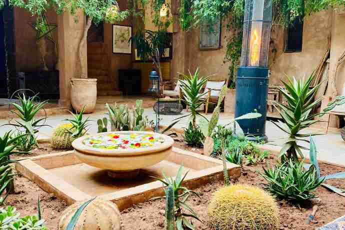 Lunch in the Atlas mountains at Kasbah Bab Ourika during your pilates holiday.